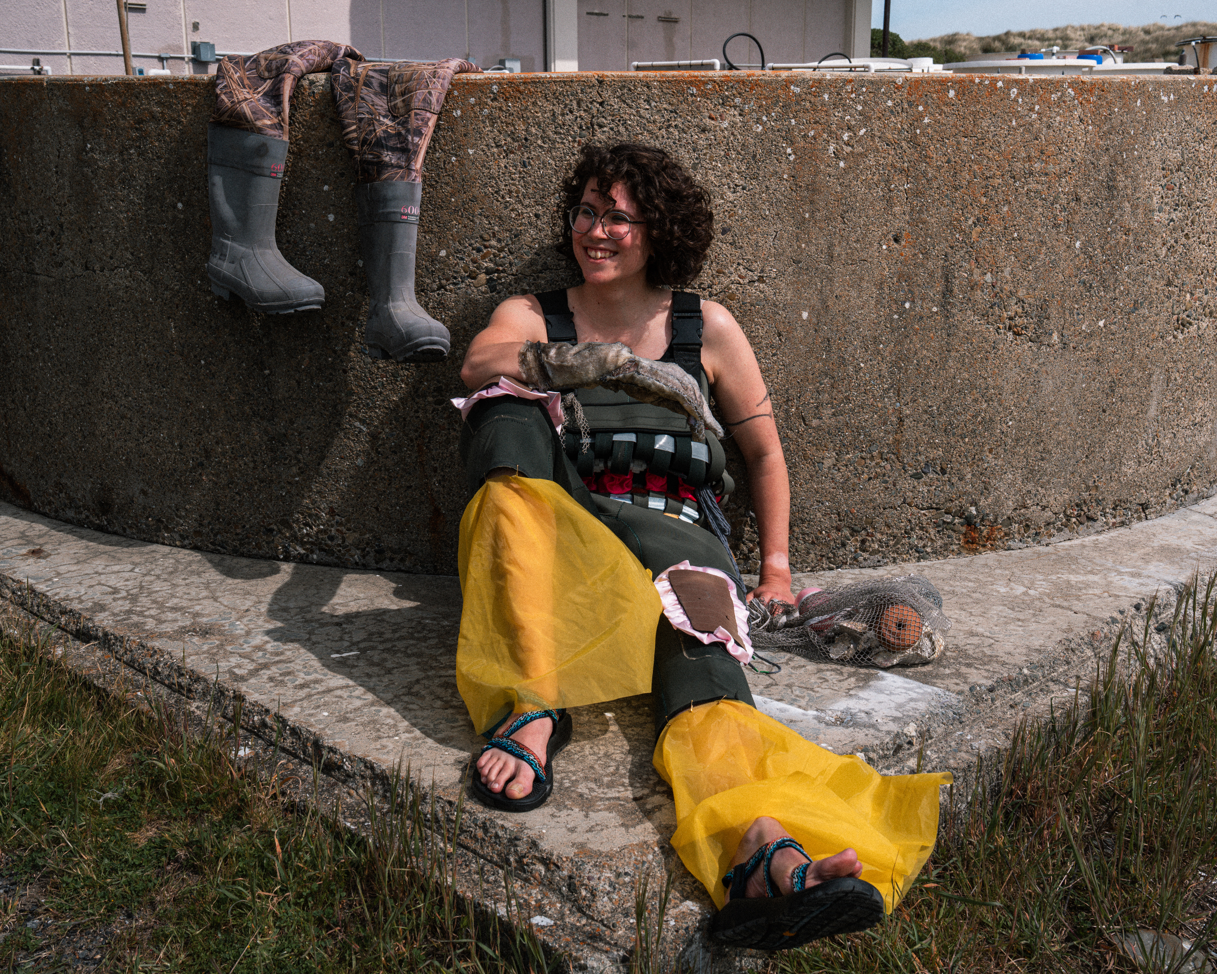 Claire wearing upcyled waders and fish leather glove