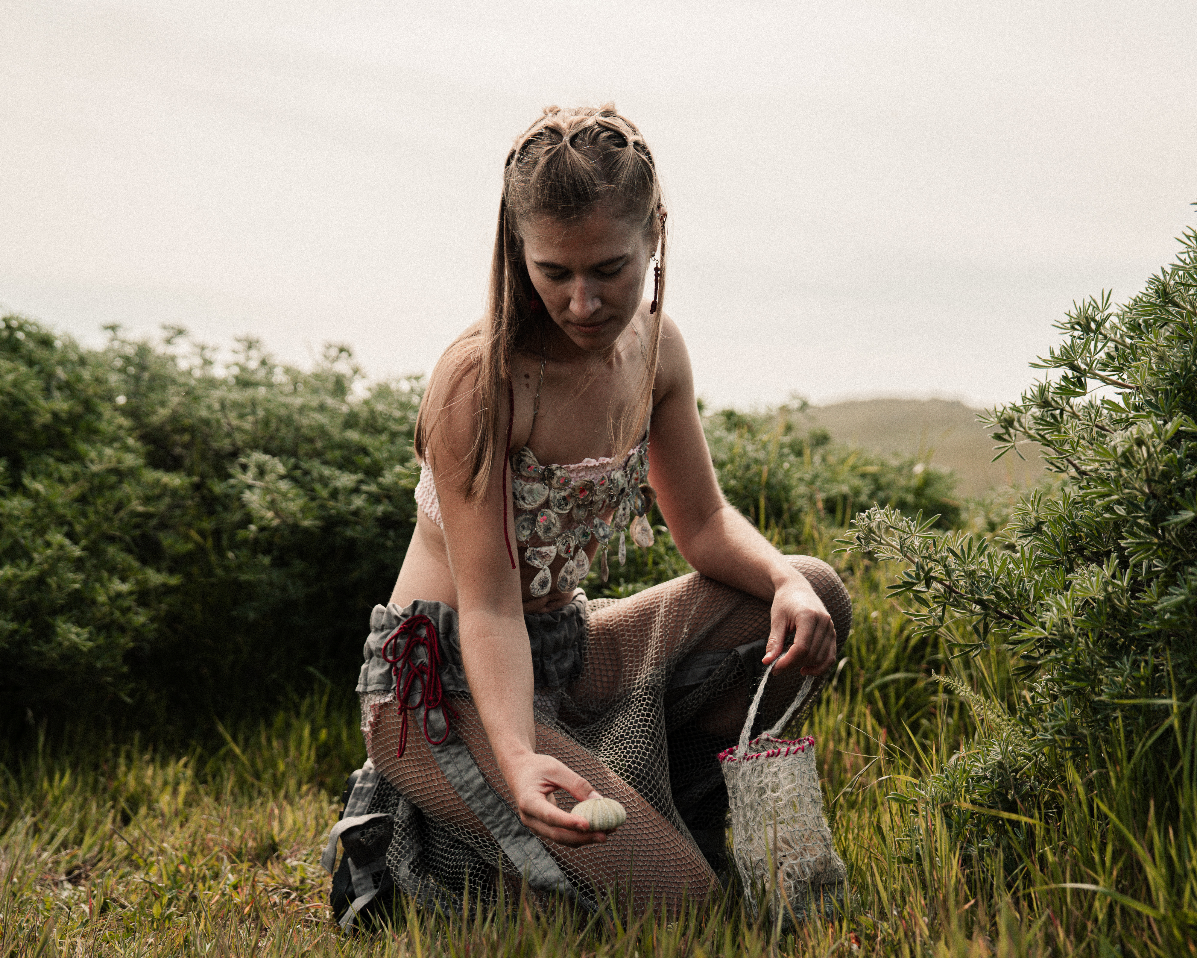 Kenzie wearing shell top with net pants
